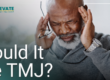man holding his temples with a headache
