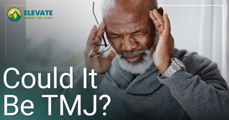 man holding his temples with a headache